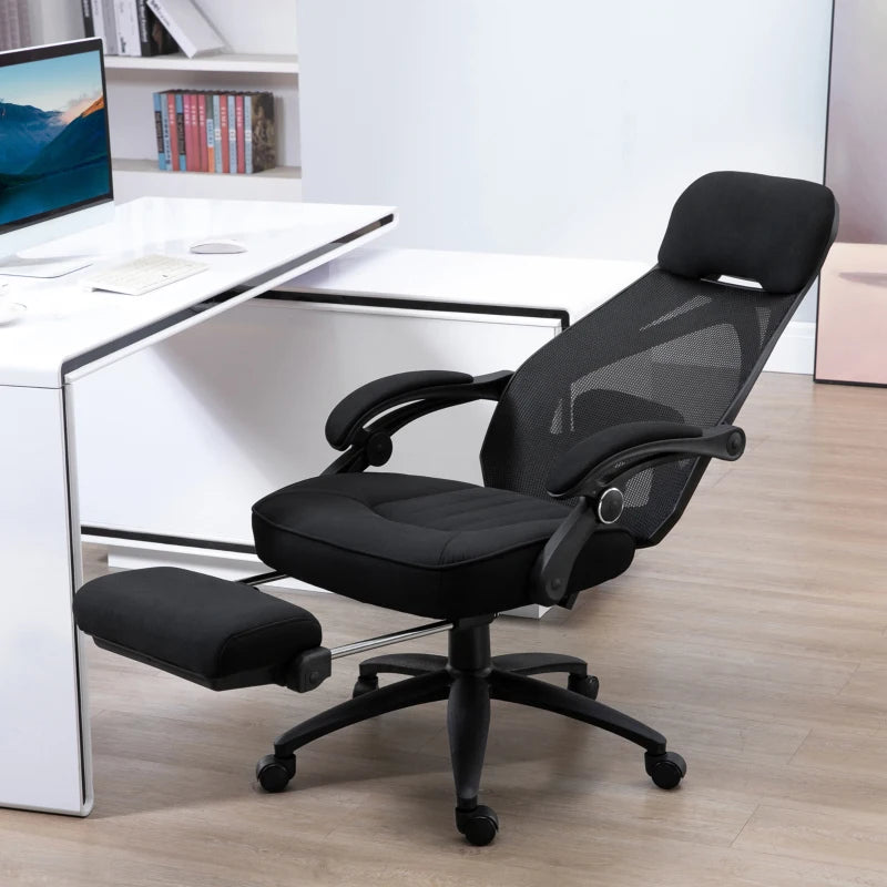 Black office chair with footrest in a modern office setting