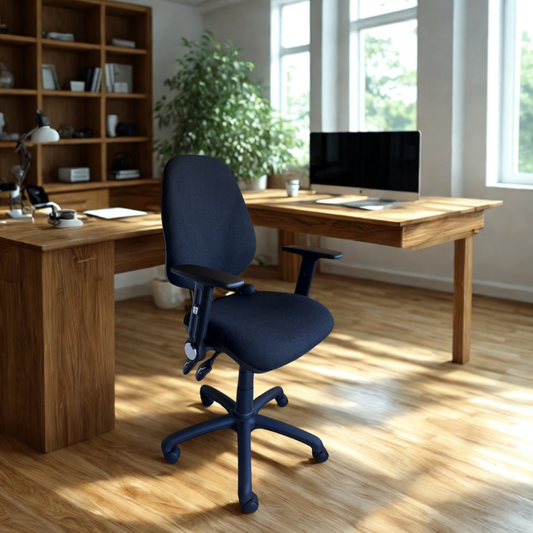 Black office chair in front of a wooden desk with a computer setup in a bright room.