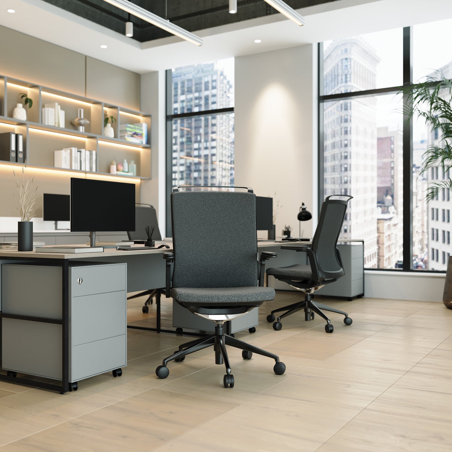 Modern office space with desks, chairs, and large windows overlooking a cityscape.