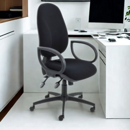 Black office chair in a modern office setting with white desks and computer equipment.