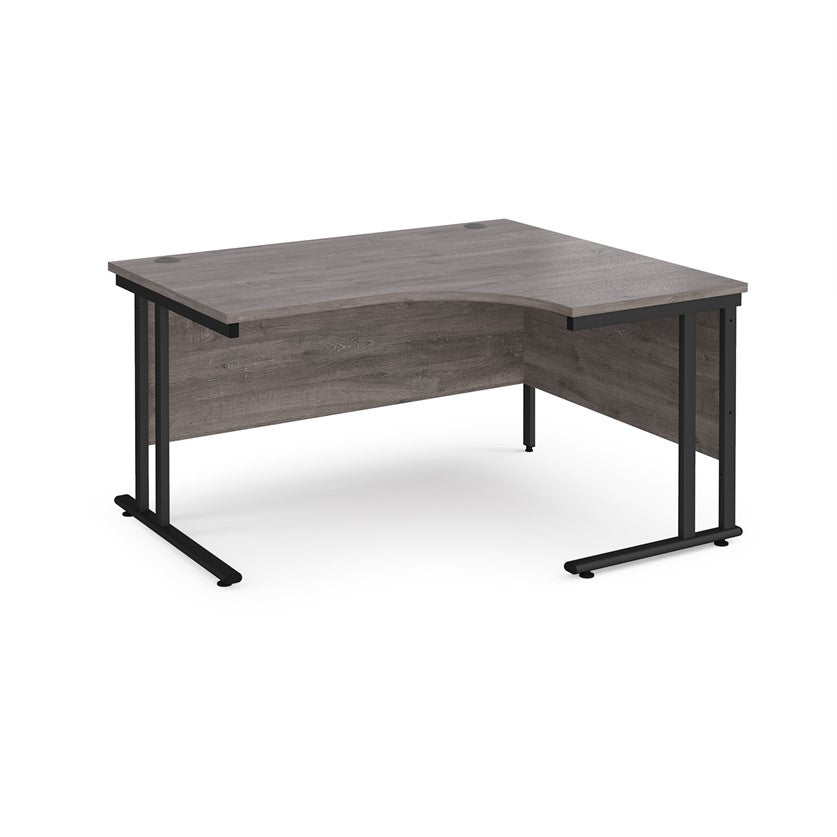 A right-hand ergonomic desk with a grey melamine tabletop and black cantilever metal frame.