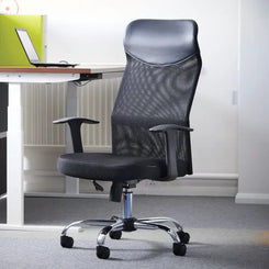 Black office chair in front of a desk with a computer monitor.