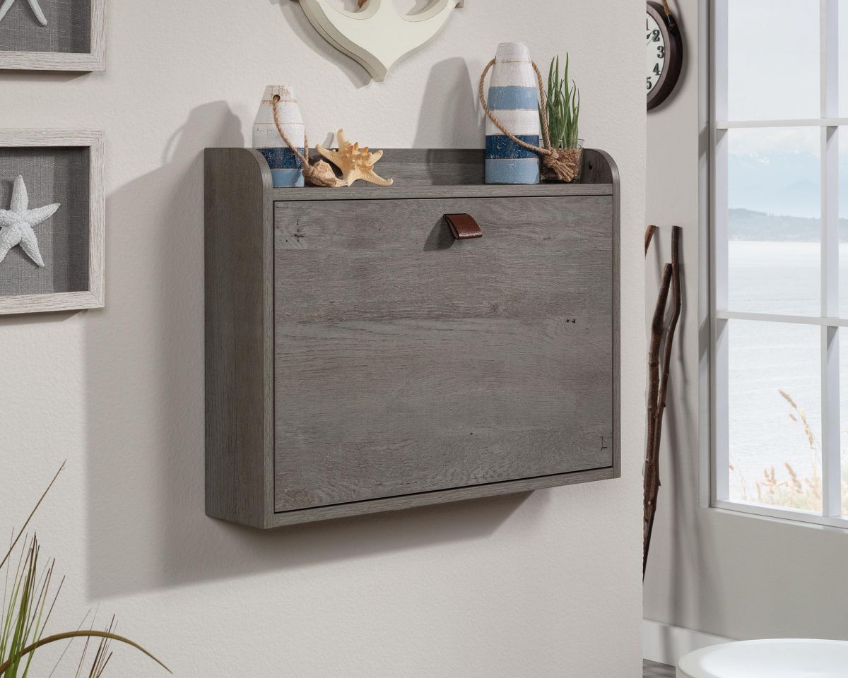 Wall-mounted desk with decorative items on a wall.