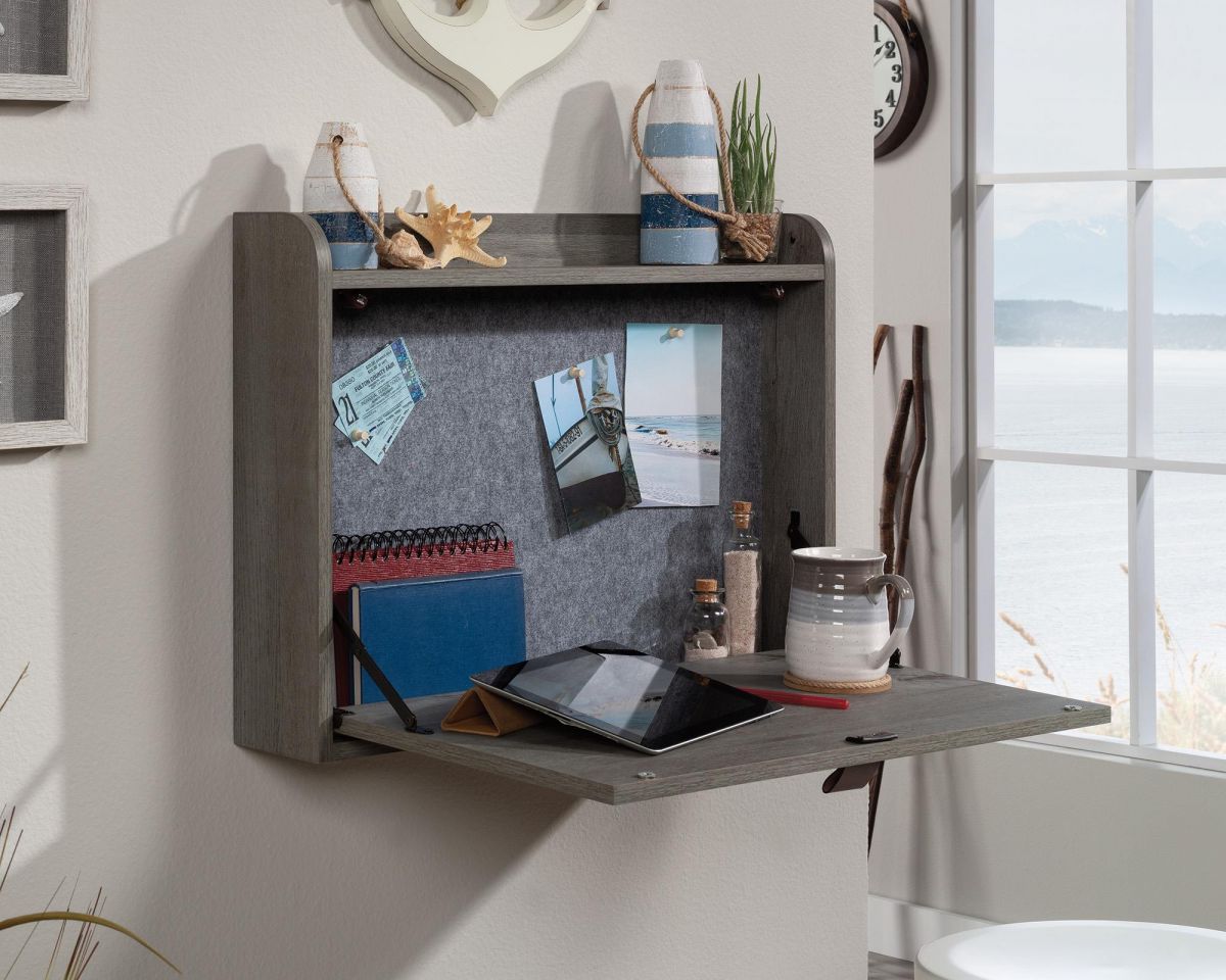 Wall-mounted desk with a tablet on a light gray wall.