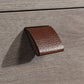 Brown leather handle on a wooden surface