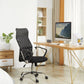 Modern office setup with a black mesh office chair, wooden desk, and computer monitor.