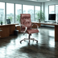 Brown leather office chair in a modern office setting with large windows.
