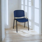 Blue chair with black legs in a room with sunlight filtering through curtains