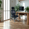 Ergonomic office chair in a home office setting with a desk and computer.
