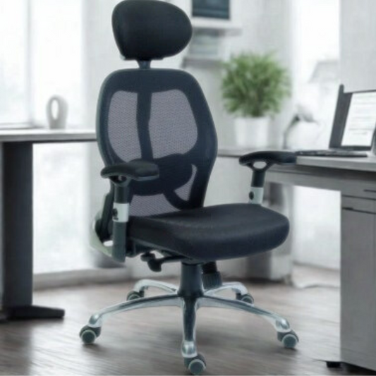 Black office chair in a bright room with a desk and computer.