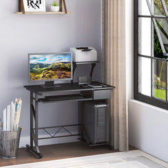 A black computer desk with a monitor, keyboard, and a notebook placed on it. The desk has a sliding keyboard tray, a drawer, and a CPU stand.