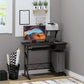 A brown computer desk with a display stand, keyboard tray drawer, and host box shelf. It is set in a room with a wall-mounted shelf above it and a variety of items on and around the desk.