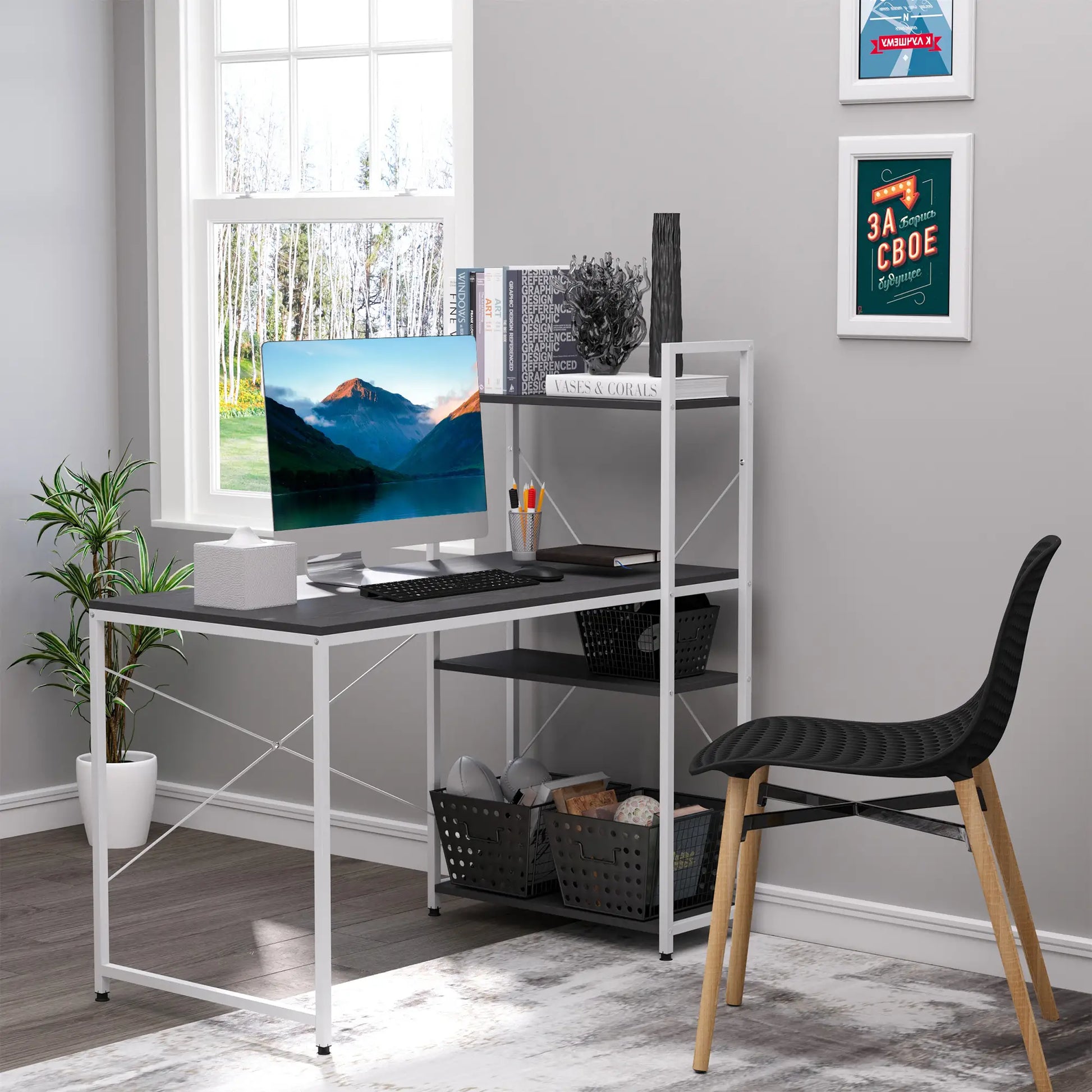 A black and white computer desk with storage shelves on the left side, featuring a monitor, plants, and other desk accessories.