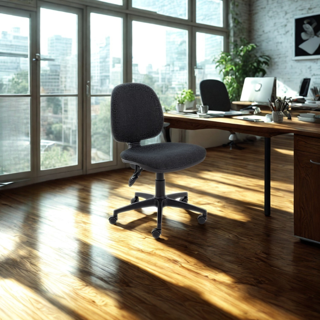 Modern office setup with a desk and chair in a bright room with large windows.