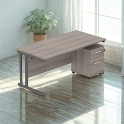 Wooden office desk with a cabinet in a bright room with natural light