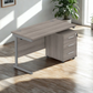 Wooden office desk with drawers in a bright room with natural light