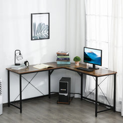 An L-shaped corner gaming desk with a black metal frame and brown wooden tabletop, equipped with a computer monitor and keyboard, set in a room with a window and wall art.
