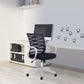 Black office chair in a modern office setting with a desk and computer monitor.