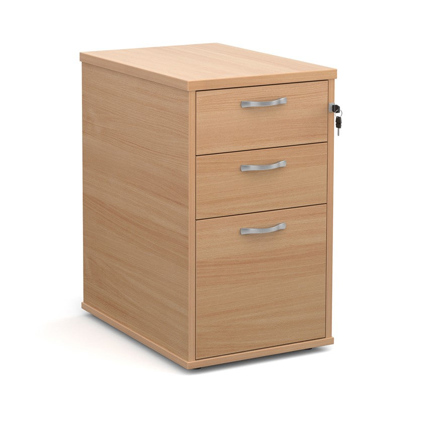 A wooden mobile pedestal with three drawers, lockable with silver handles, in an office setting.