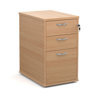 A wooden mobile pedestal with three drawers, lockable with silver handles, in an office setting.