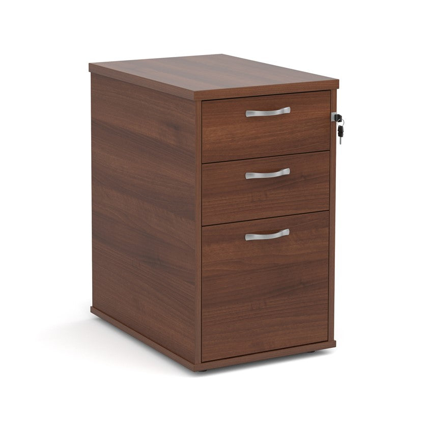 A wooden mobile pedestal with three drawers, lockable with silver handles, in an office setting.