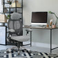 Ergonomic office chair in front of a computer desk with a monitor in a home office setting.