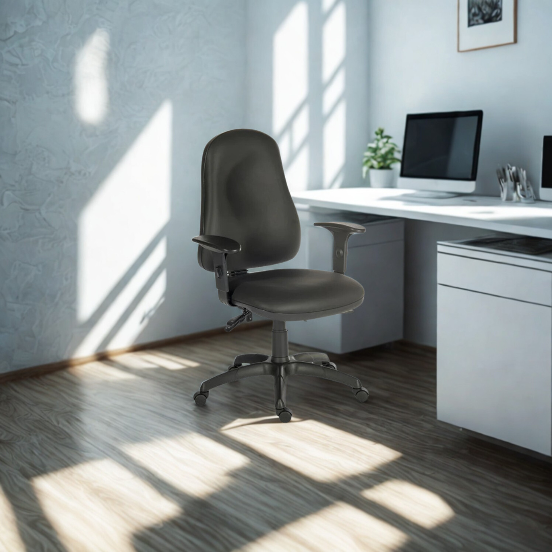 Modern office desk with a gray chair and computer setup in a bright room.
