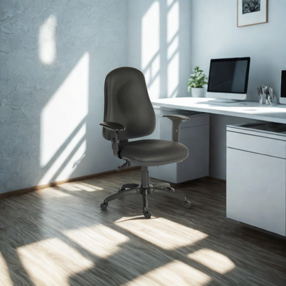 Modern office desk with a gray chair and computer setup in a bright room.