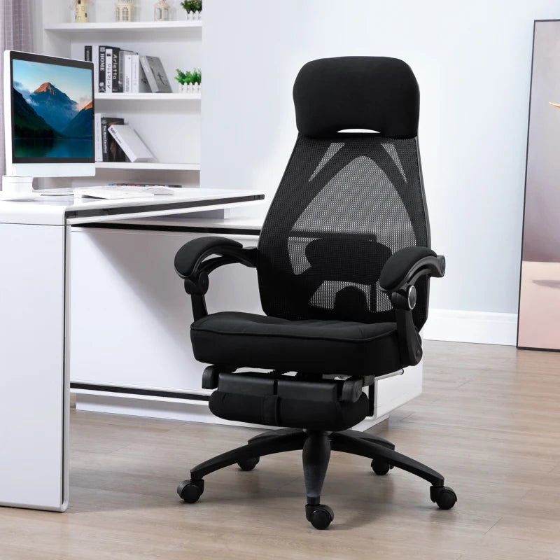Black office chair in a modern office setting with a computer desk.