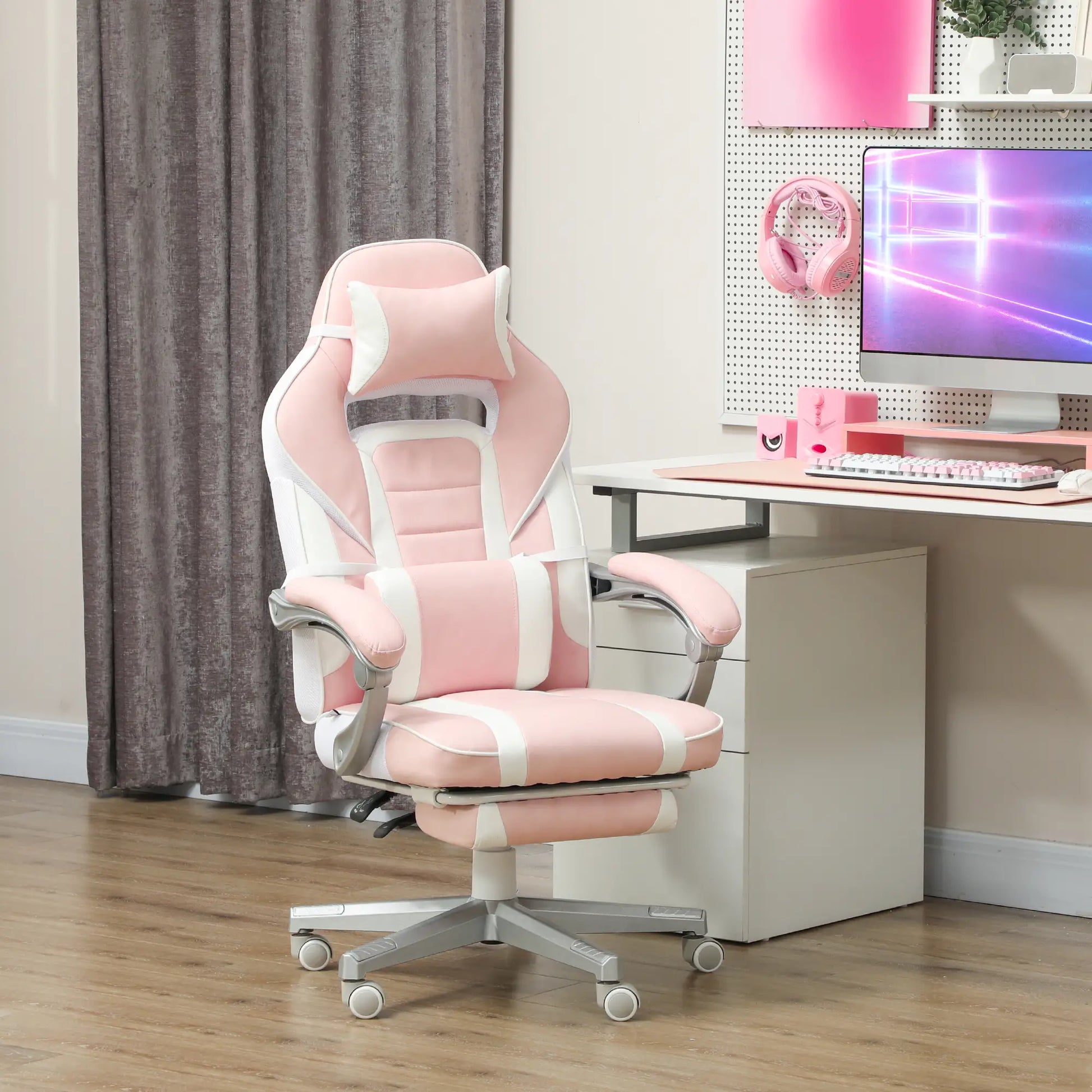 A pink and white faux leather reclining gaming chair with footrest, positioned in an office setting.