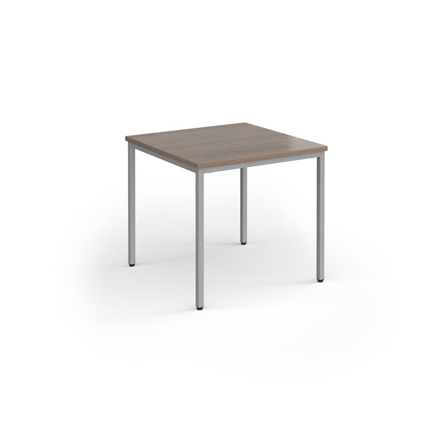 A rectangular conference room table with a wood-like tabletop and a gray steel frame.