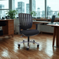 Black office chair in an office setting with large windows and cityscape view