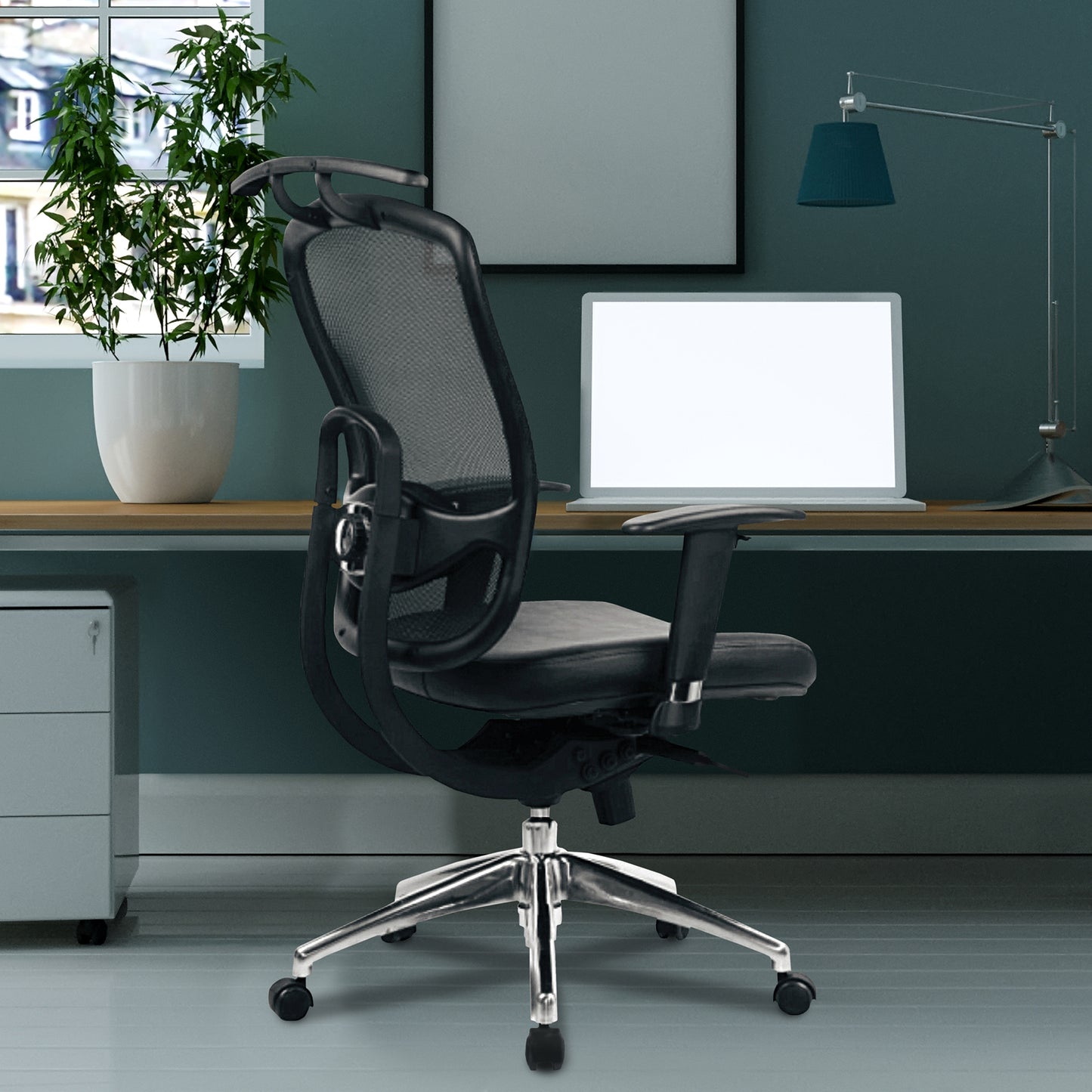 Black office chair in a modern office setting with a desk, computer, and plant.