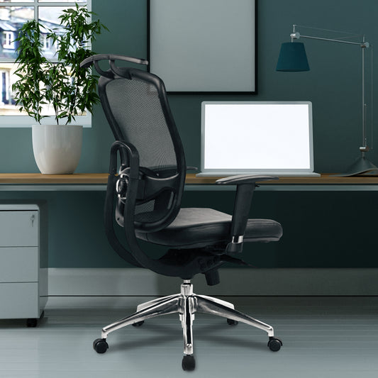 Black office chair in a modern office setting with a desk, computer, and plant.