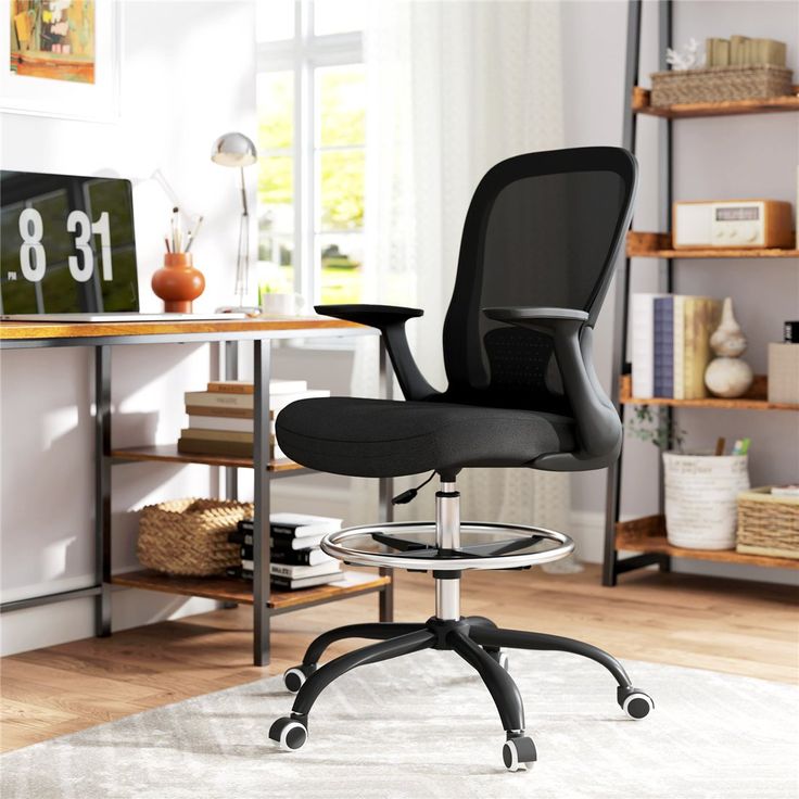 Black mesh draughtsman chair with a foot ring, height adjustable for bench and counter work