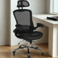 Black ergonomic office chair in a room with a desk.