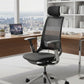 Modern office chair in a bright room with a city view