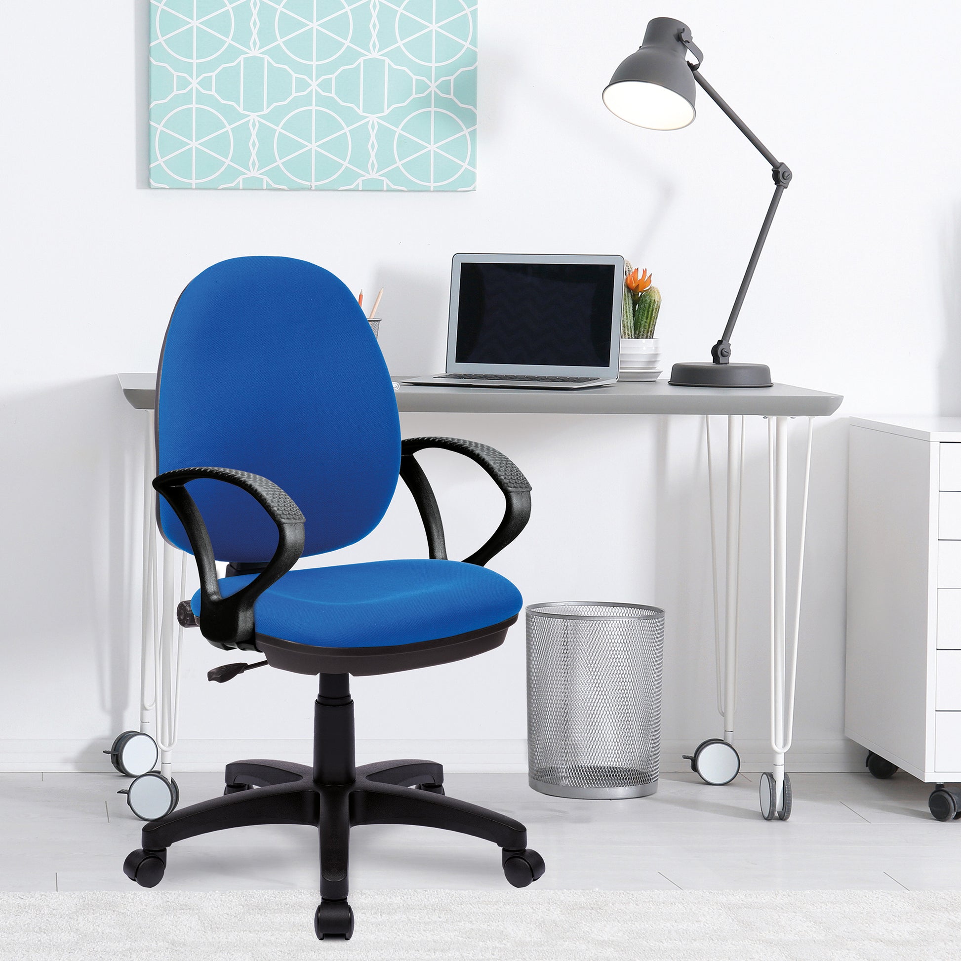 Blue office chair in a modern office setting with a desk, laptop, and lamp.