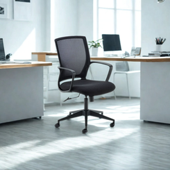 Black office chair in a modern office setting with desks and computers.