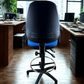 Black office chair with blue seat in an office setting