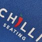 Embroidered logo on blue fabric with 'CHILLI SEATING' text and red chili pepper.