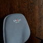 Blue office chair with 'Chilli Seating' logo against a wooden wall.