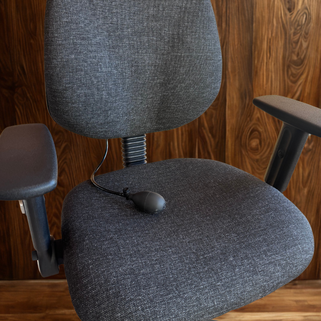 Gray office chair against a wooden wall