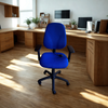 Blue office chair in a home office setting with wooden desks and computer equipment.
