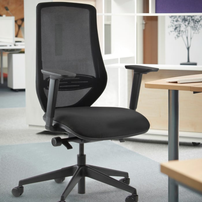 Black office chair in an office setting with desks and chairs.