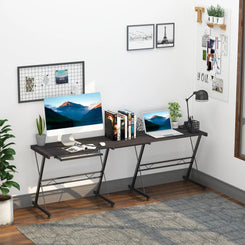 An L-shaped gaming desk with a black metal frame and solid MDF tabletops, featuring a round corner design and a slide-out keyboard tray, set in a room with various decor.