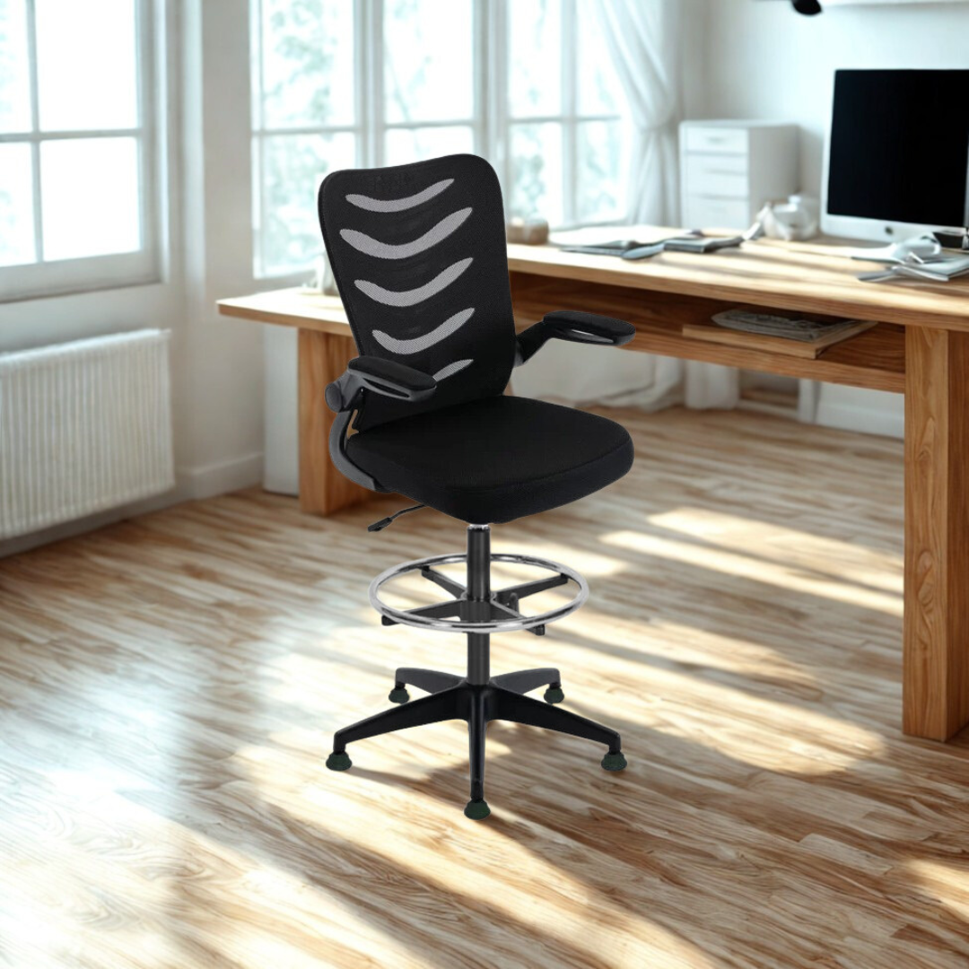 Black office chair in a bright room with a desk and computer.