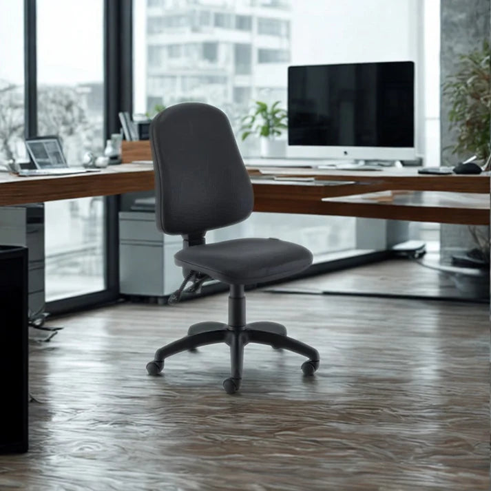 Gray office chair in front of a wooden desk with a computer setup in a modern office.