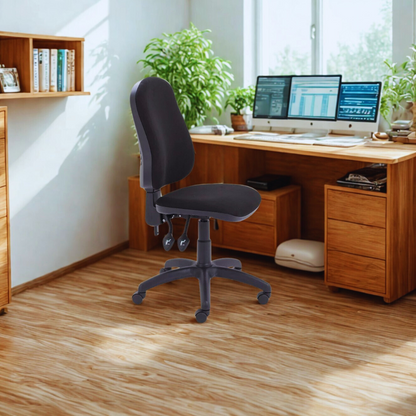 Home office with wooden desk, computer setup, and office chair.