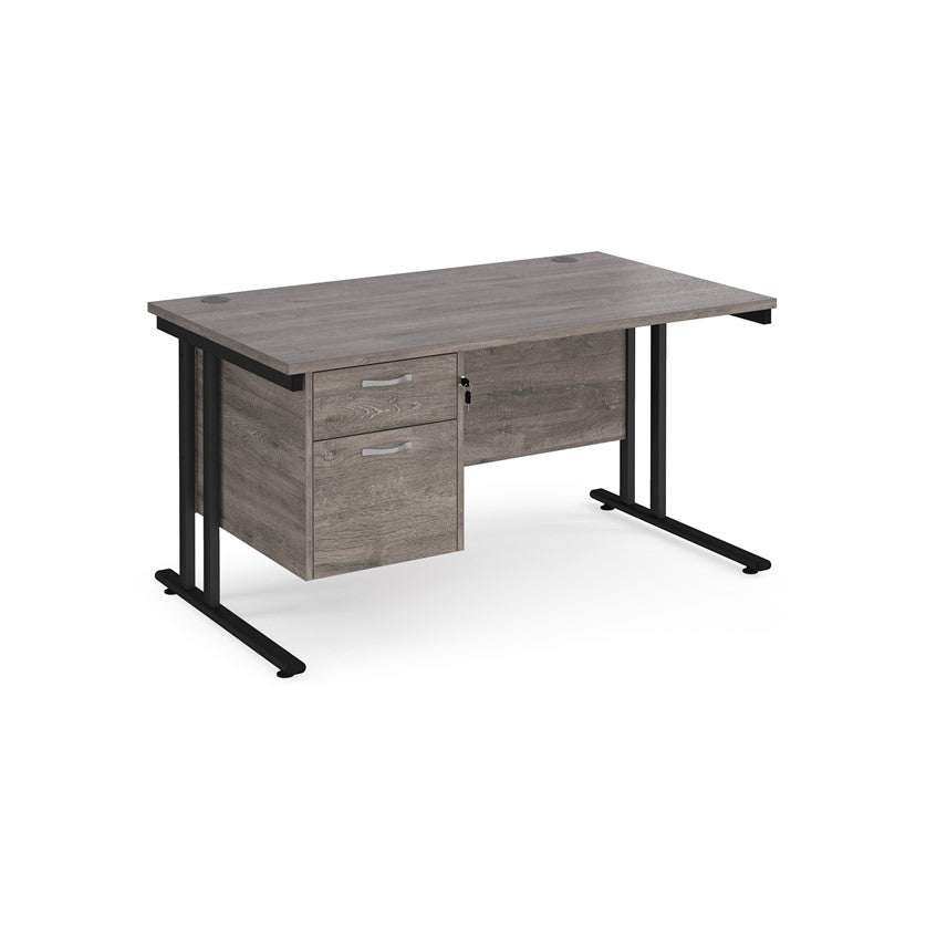 Rectangular office desk with a black cantilever frame and a grey two-drawer fixed pedestal. The desk has a melamine finish and is pictured against a white background.